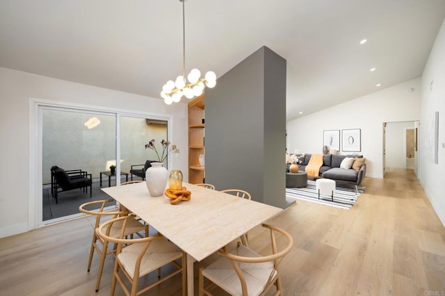 dining area featuring light wood-style floors, recessed lighting, high vaulted ceiling, and an inviting chandelier