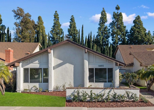 exterior space with a yard and stucco siding