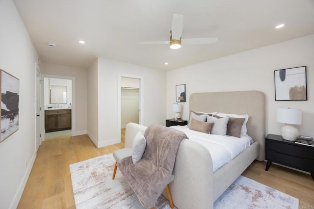 bedroom with light wood finished floors, baseboards, and recessed lighting