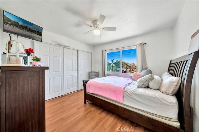 bedroom featuring light wood-style floors, a closet, and ceiling fan