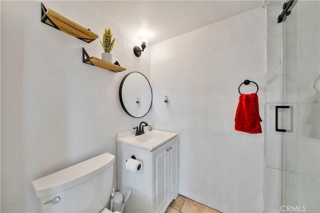 full bathroom featuring toilet, tile patterned floors, an enclosed shower, a textured ceiling, and vanity