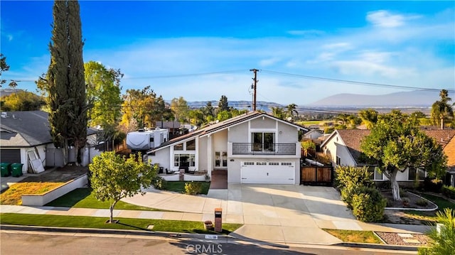 view of front facade featuring a garage, concrete driveway, fence, and stucco siding