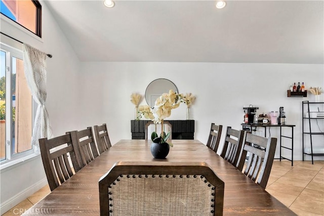 tiled dining room featuring lofted ceiling, baseboards, and recessed lighting