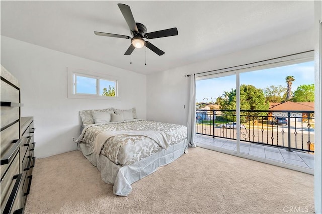 carpeted bedroom with a ceiling fan and access to outside