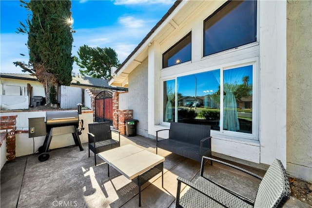 view of patio with fence and an outdoor hangout area