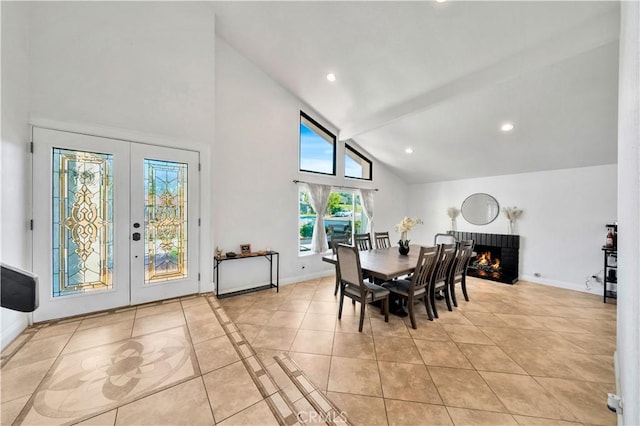 dining area featuring french doors, light tile patterned floors, recessed lighting, a brick fireplace, and baseboards