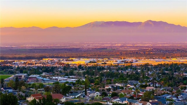 aerial view at dusk featuring a residential view and a mountain view