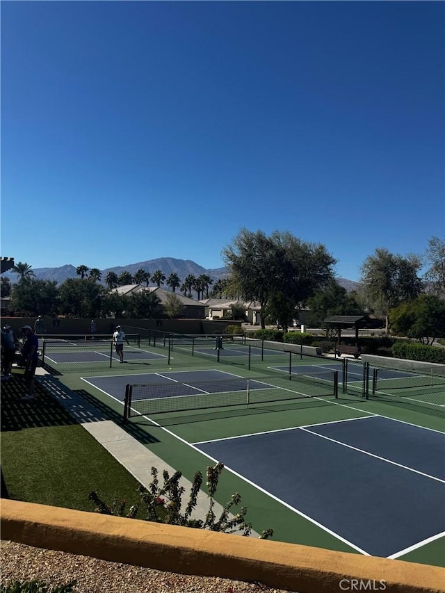 view of sport court with fence and a mountain view