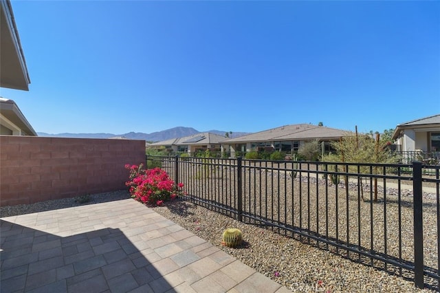 view of patio / terrace featuring a fenced backyard and a mountain view