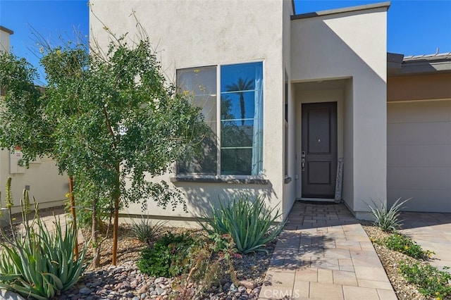 property entrance with stucco siding