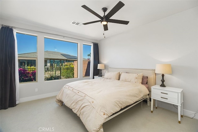 carpeted bedroom with a ceiling fan, visible vents, and baseboards