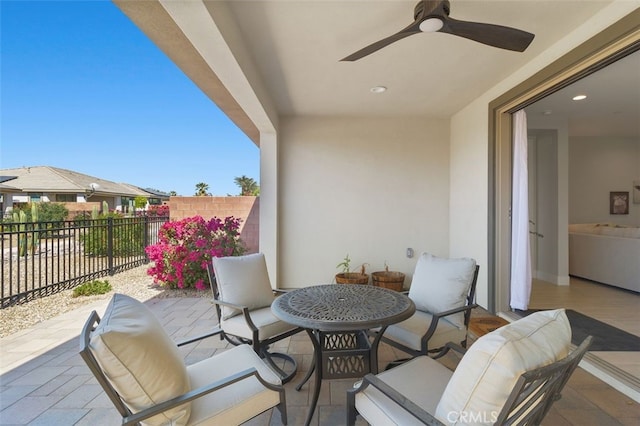 view of patio / terrace featuring fence and a ceiling fan