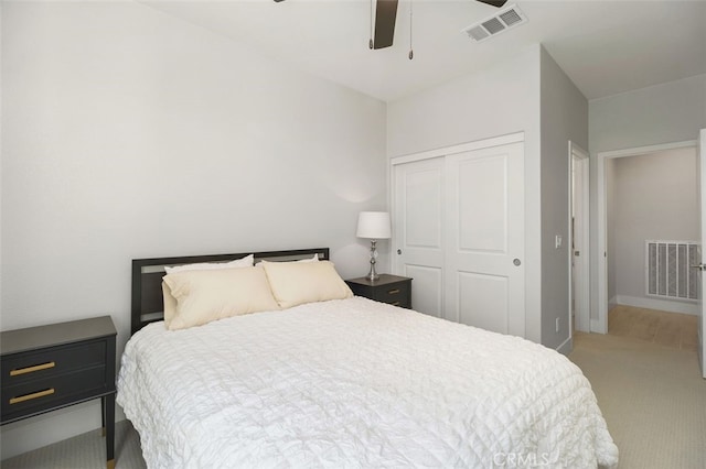 carpeted bedroom with a closet, visible vents, ceiling fan, and baseboards