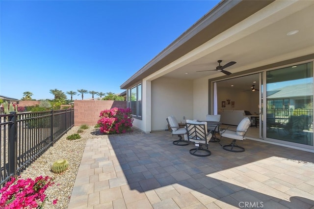 view of patio with a ceiling fan, outdoor dining area, and a fenced backyard