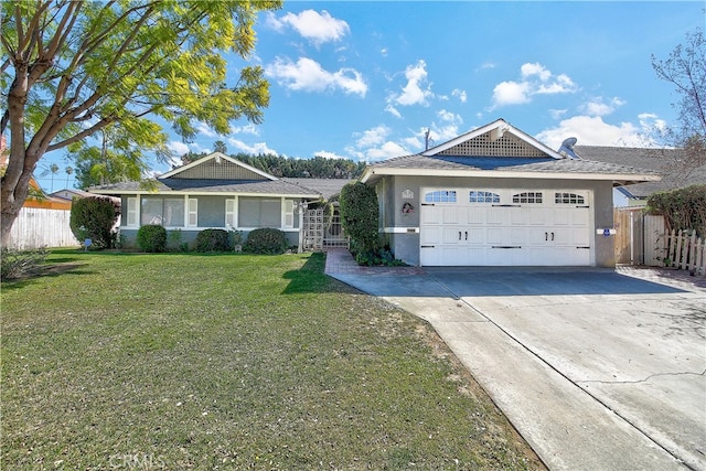 ranch-style house featuring driveway, an attached garage, fence, a front lawn, and stucco siding