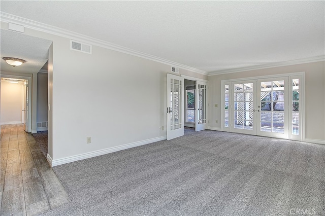 unfurnished room with a textured ceiling, visible vents, baseboards, french doors, and crown molding