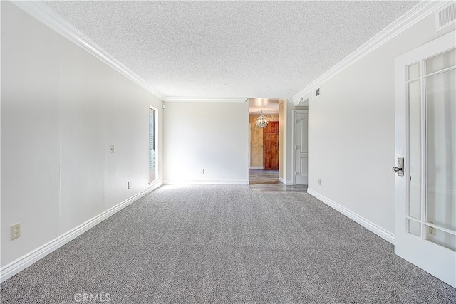 unfurnished room featuring a textured ceiling, ornamental molding, carpet flooring, and visible vents