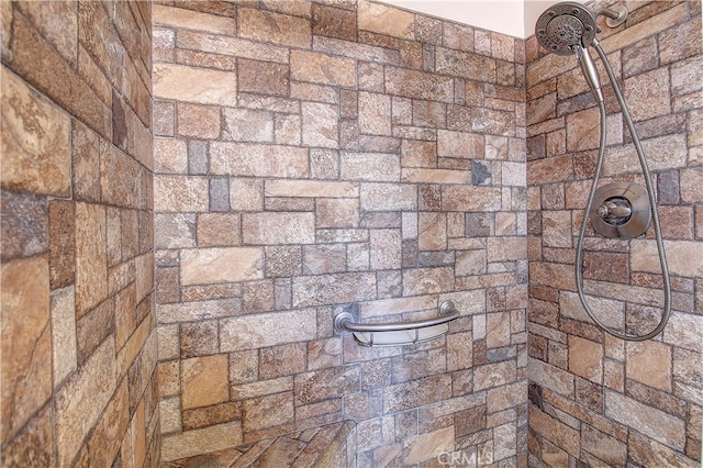 bathroom with a tile shower