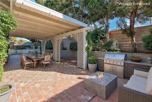 view of patio with an outdoor fire pit, outdoor dining area, a fenced backyard, and area for grilling