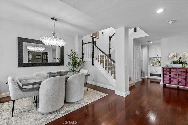 dining space featuring recessed lighting, an inviting chandelier, wood finished floors, baseboards, and stairs