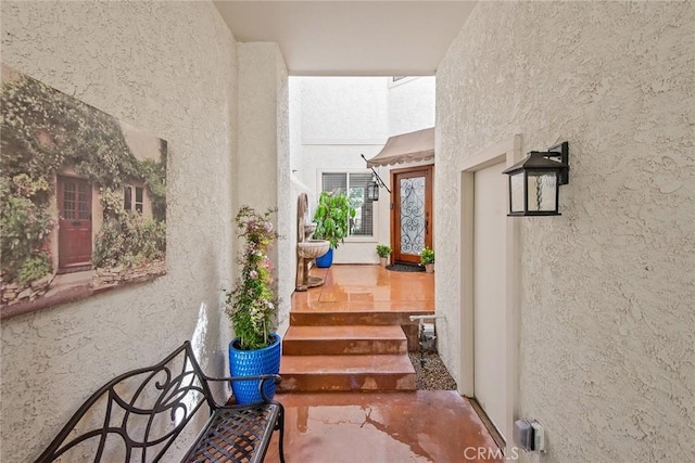 property entrance with stucco siding