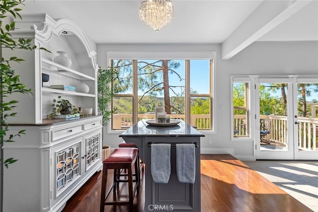 interior space with baseboards, french doors, dark wood-style flooring, and a notable chandelier