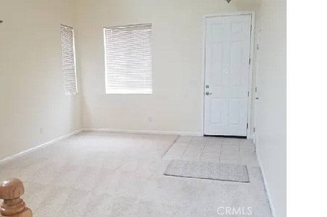 unfurnished room with baseboards