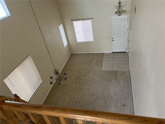 carpeted foyer entrance with baseboards