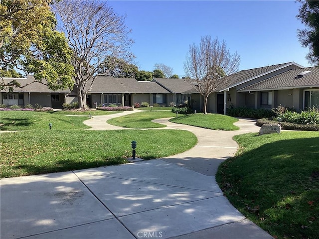 view of home's community featuring a yard