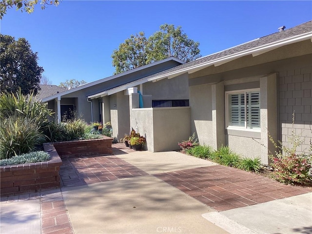 view of front of home with a patio area and stucco siding