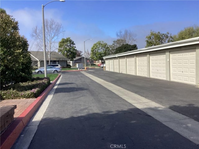 view of road with street lighting, a residential view, and community garages