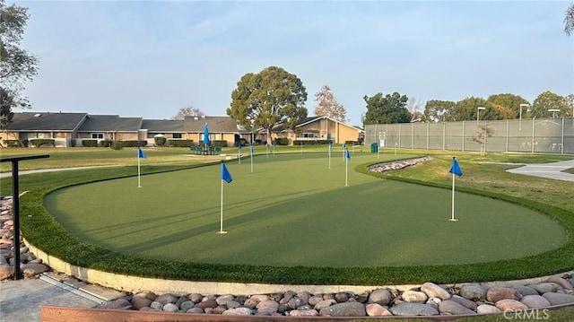 view of property's community with a yard, a residential view, and fence