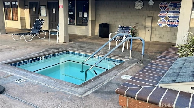 view of pool featuring a hot tub