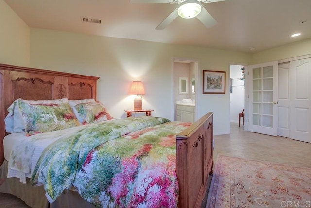 bedroom with light floors, visible vents, a ceiling fan, and ensuite bathroom