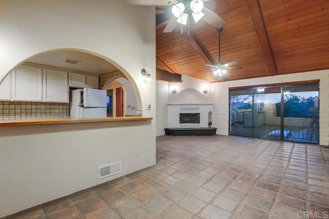 unfurnished living room featuring beam ceiling, visible vents, ceiling fan, high vaulted ceiling, and wooden ceiling