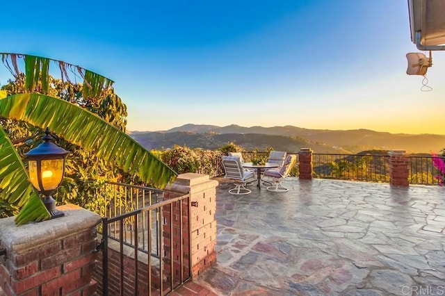 view of patio / terrace featuring outdoor dining space and a mountain view