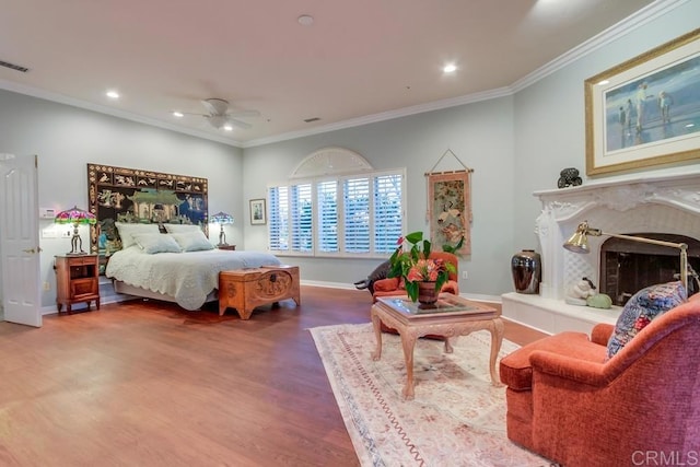 bedroom with baseboards, a high end fireplace, wood finished floors, crown molding, and recessed lighting