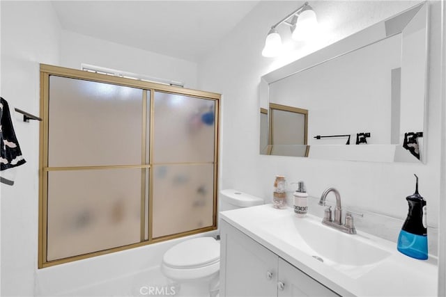 bathroom with shower / bath combination with glass door, vanity, and toilet