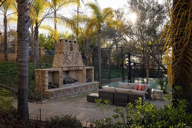 view of patio / terrace featuring an outdoor living space with a fireplace and fence