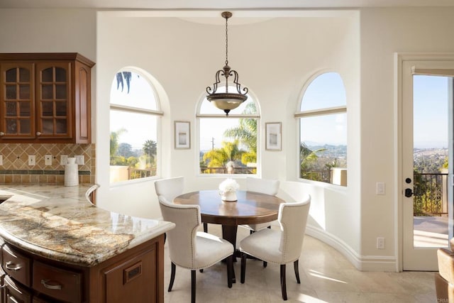 dining room featuring light tile patterned floors and baseboards