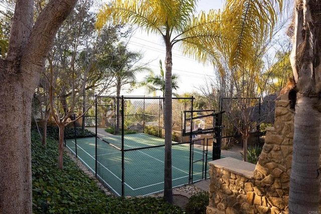 view of sport court featuring community basketball court, a gate, a tennis court, and fence