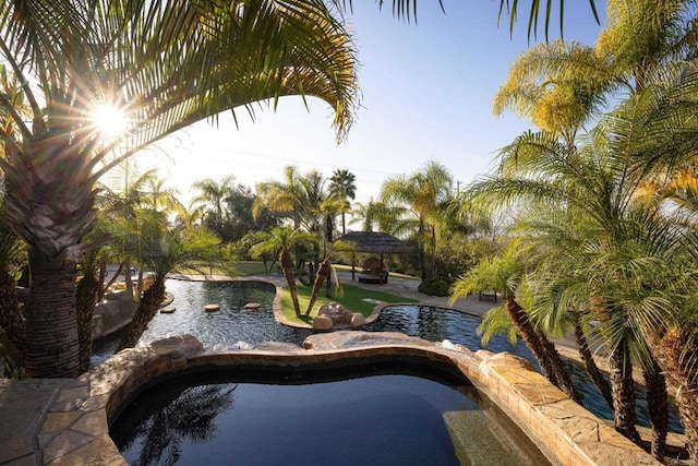 pool with a patio area and a gazebo