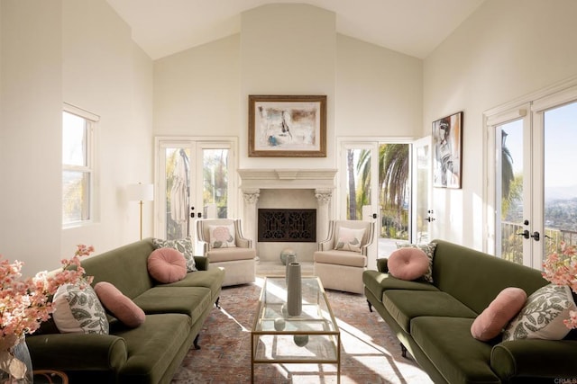 living room featuring high vaulted ceiling, french doors, a fireplace, and a wealth of natural light