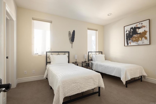 carpeted bedroom featuring baseboards