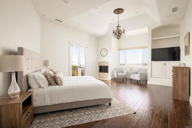 bedroom with dark wood-style flooring, recessed lighting, visible vents, and an inviting chandelier