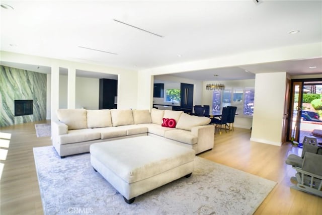 living area featuring a fireplace and light wood-style floors