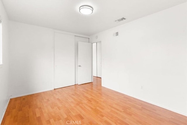 spare room with light wood-type flooring and visible vents