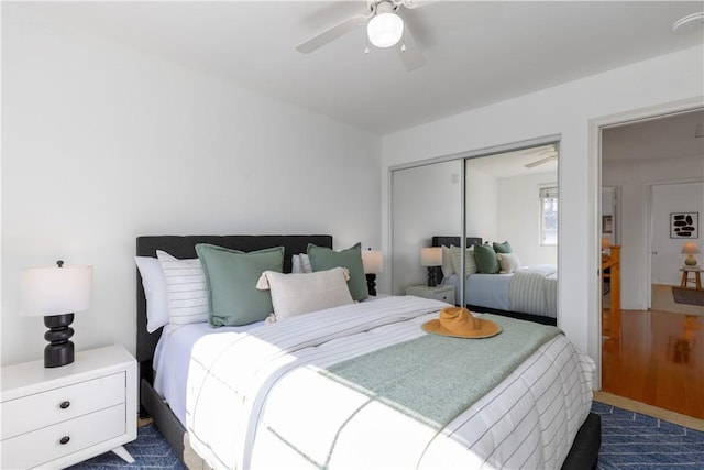 bedroom with dark colored carpet, a closet, and ceiling fan