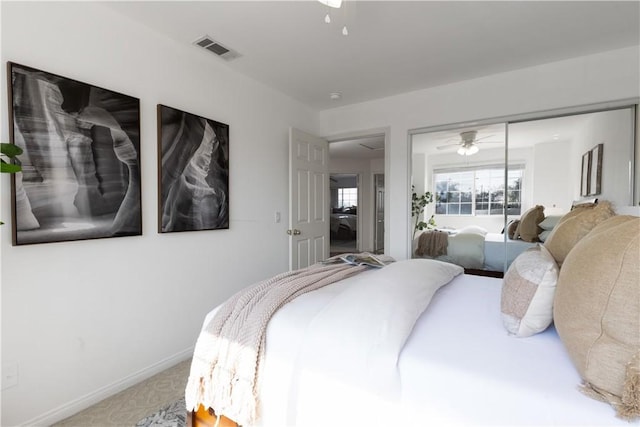 carpeted bedroom featuring baseboards, visible vents, ceiling fan, and a closet