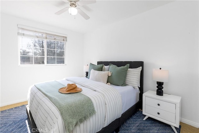 bedroom with a ceiling fan and baseboards